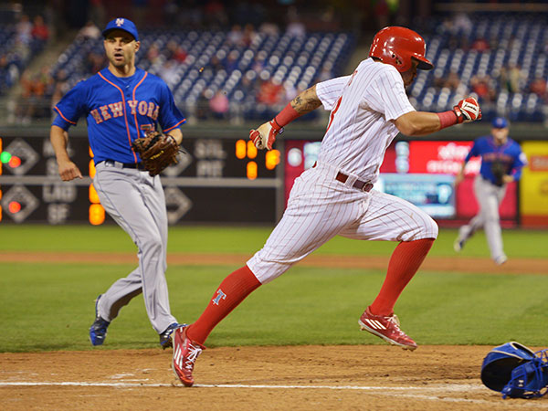 Freddy Galvis #13 of the Phillies scores on a wild pitch by Carlos Torres #72 of the New York Mets in the sixth inning at Citizens Bank Park