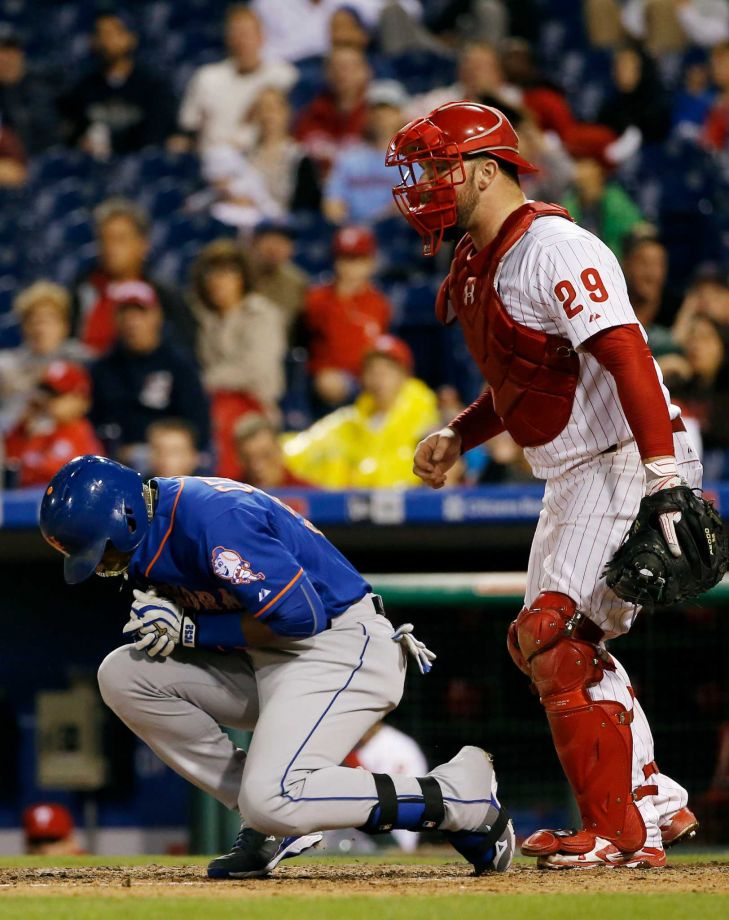 New York Mets Yoenis Cespedes left reacts after being hit by a pitch from Philadelphia Phillies Justin De Fratus as catcher Cameron Rupp looks on during the third inning of a baseball game Wednesday Sept. 30 2015 in Philadelphia