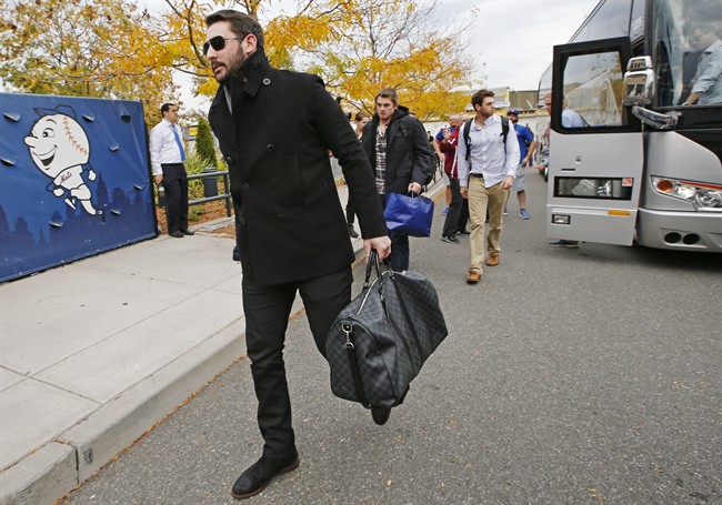 New York Mets pitcher Matt Harvey left and Steven Matz third from left walk to the parking lot at Citi Field after the Mets plane landed in New York from Chicago Thursday Oct. 22 2015. The Mets won the National League Championship pennant after swee