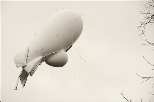 An unmanned Army surveillance blimp floats through the air while dragging a tether line just south of Millville Pa. Wednesday Oct. 28 2015. The bulbous 240-foot helium-filled blimp came down near Muncy a small town about 80 miles north of Harrisburg