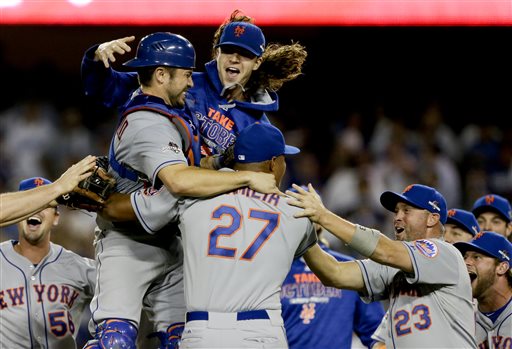 New York Mets starting pitcher Jacob deGrom above right catcher Travis d'Arnaud left and other Mets players celebrate a 3-2 win over the Los Angeles Dodgers in Game 5 of baseball's National League Division Series on Thursday Oct. 15 2015 in Los Ang