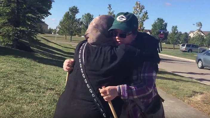 Muslim woman Cynthia De Boutinkhar hugs anti Muslim protester Annie out the front of Noor Islamic Cultural Center in Columbus Ohio