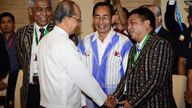 Myanmar’s President Thein Sein shakes hands with Lian Hmung Sakhong of the Chin National Front a member of the Nationwide Ceasefire Coordination Team during a meeting in Naypyidaw