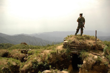 A soldier with the Kachin Independence Army overlooks a Myanmar army position in this May 2012