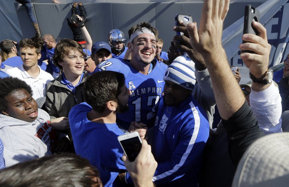 Paxton Lynch celebrates with fans after beating Ole Miss Memphis’ 1st win over a ranked opponent since 1996