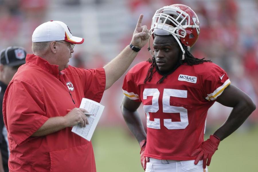 Kansas City Chiefs running back Jamaal Charles listens to coach Andy Reid during NFL football training camp Sunday