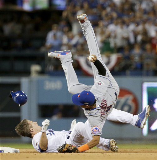 New York Mets shortstop Ruben Tejada goes over the top of Los Angeles Dodgers Chase Utley who broke up a double play during the seventh inning in Game 2 of baseball's National League Division Series Saturday Oct. 10 2015 in Los Angeles. (AP