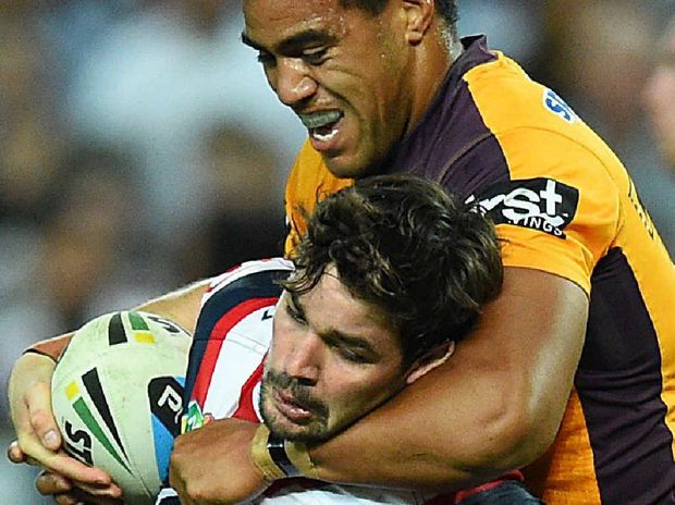 COP THAT Aidan Guerra of the Roosters is hammered by Broncos prop Joe Ofahengaue. Big Joe will come off the bench in tomorrow’s NRL grand final