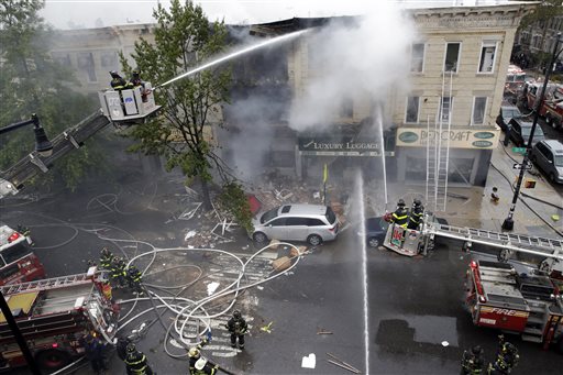 Firefighters work at the at the scene of an explosion at a three-story building in the Borough Park neighborhood in the Brooklyn borough of New York Saturday Oct. 3 2015. Fire Commissioner Daniel Nigro says the explosion apparently happened after a sto