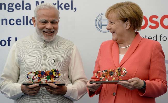 German Chancellor Angela Merkel and PM Narendra Modi share a warm handshake