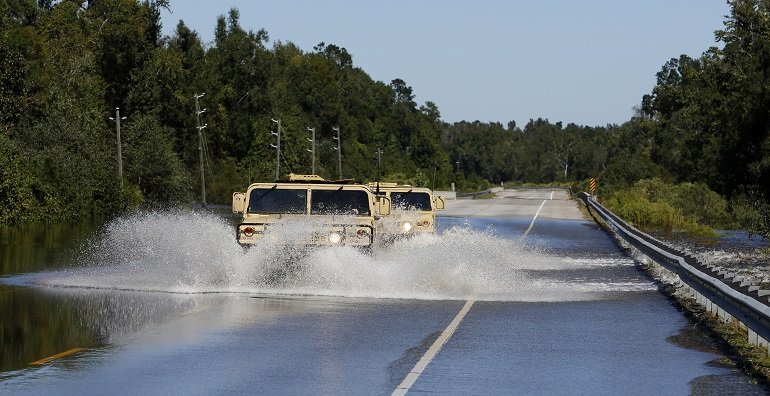 National Guard humvees plow through flood waters on Highway 377 near Kingstree S.C. Wednesday Oct. 7 2015. AP