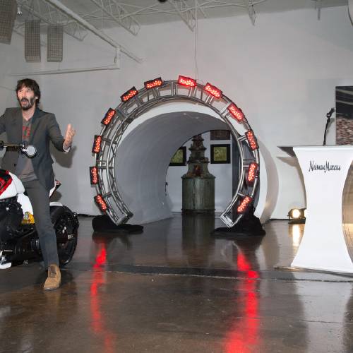 Marcus actor and Arch Motorcycles co-owner Keanu Reeves left is introduced by John Koryl president of Neiman Marcus Stores and Online at Neiman Marcus as he rides an Arch Motorcycle during the launch of the Ne