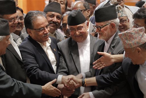 Nepal's newly-elected Prime Minister KP Sharma Oli greets supporters as he leaves the parliament in Kathmandu on 11 October 2015