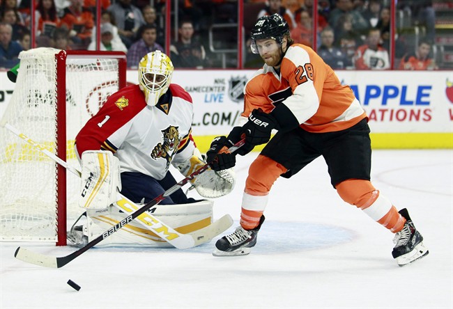 Philadelphia Flyers Claude Giroux right moves towards the puck as Florida Panthers Roberto Luongo defends during the second period of an NHL hockey game Monday Oct. 12 2015 in Philadelphia