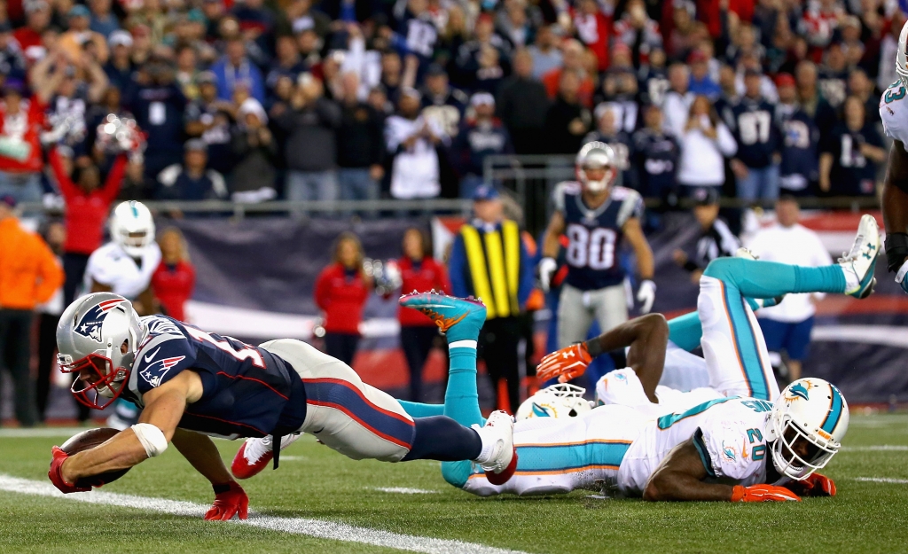 FOXBORO MA- OCTOBER 29 Julian Edelman #12 of the New England Patriots scores a touchdown during the fourth quarter against the Miami Dolphins at Gillette Stadium