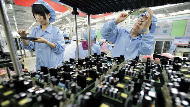 Employees working at a production line of electronic panels at a factory of Fibre #Home Technologies Group in Wuhan China