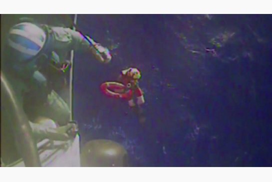 U.S. Coast Guard members retrieve a life preserver ring from the cargo ship El Faro in this image grabbed from a handout video provided by the Coast Guard on Sunday. Search-and-rescue teams on Sunday located debris which appeared to belong to the El Faro