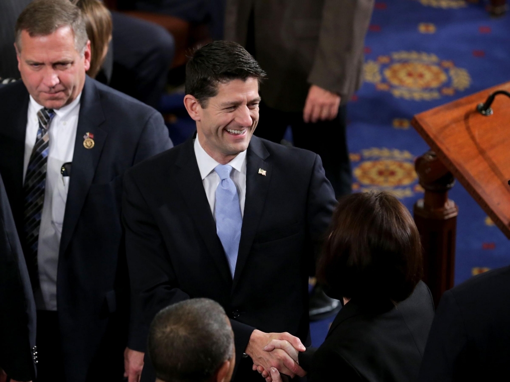 Newly elected Speaker Paul Ryan greets fellow members on the floor of the House chamber