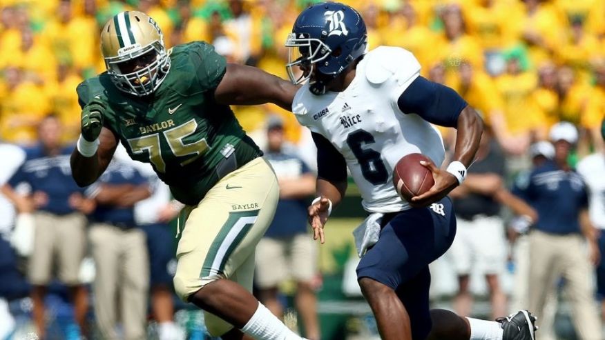 WACO TX- SEPTEMBER 26 Driphus Jackson #6 of the Rice Owls carries the ball against Andrew Billings #75 of the Baylor Bears in the first quarter at Mc Lane Stadium