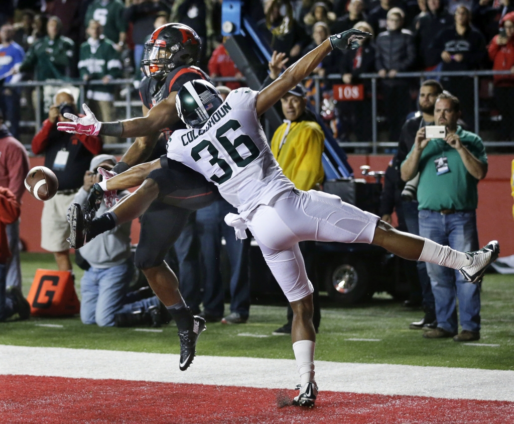 Windsor's Arjen Colquhoun right gets a hand in to break-up a pass to Rutgers wide receiver Leonte Carroo during the second half of an NCAA college football game Saturday Oct. 10 2015 in Piscataway N.J. Michigan State won 31-24. (AP