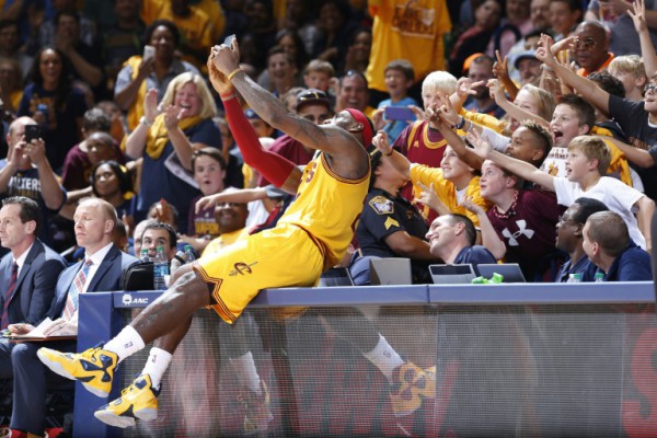 Getty  AFP  File  Joe RobbinsLeBron James of the Cleveland Cavaliers takes a selfie with young fans during a timeout in the second half of a pre-season game