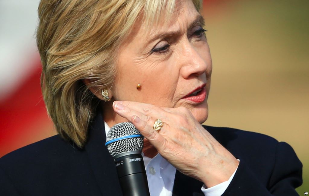 Democratic presidential candidate Hillary Rodham Clinton brushes off a lady bug that landed on her as she speaks Wednesday Oct. 7 2015 during a campaign stop at the Westfair Amphitheater in Council Bluffs Iowa