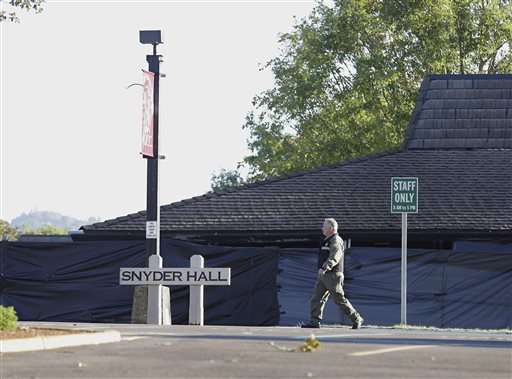 A Douglas County Sheriff's deputy walks past Snyder Hall at Umpqua Community College Sunday Oct. 4 2015 in Roseburg Ore. Armed with multiple guns suspect Chris Harper Mercer walked into a class at Snyder Hall on Thursday killing nine and wounding