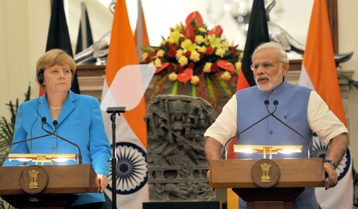 German Chancellor Angela Merkel and PM Narendra Modi share a warm handshake