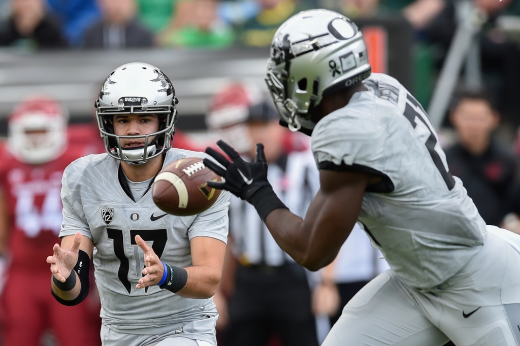 Oregon Ducks quarterback Jeff Lockie tosses the ball to Oregon Ducks running back Royce Freeman. The Oregon Ducks face the Washington State Cougars at Autzen Stadium in Eugene Oregon