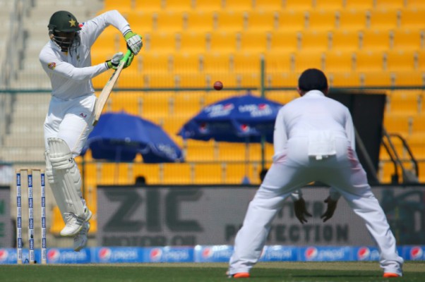 AFP  Marwan NaamaniPakistan's Shoaib Malik is watched by an England fielder as he plays a shot during the opening day of the first Test at The Sheikh Zayed International Cricket Stadium in Abu Dhabi