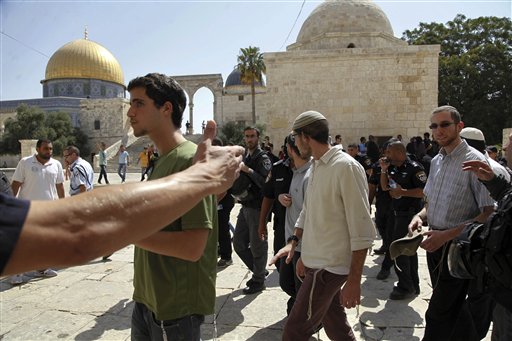 Palestinian female activists form a chain to prevent a group of religious Jews from coming close to the Dome of the Rock at the Al Aqsa compound in Jerusalem. Jewish and Muslim activists self-declared defenders of