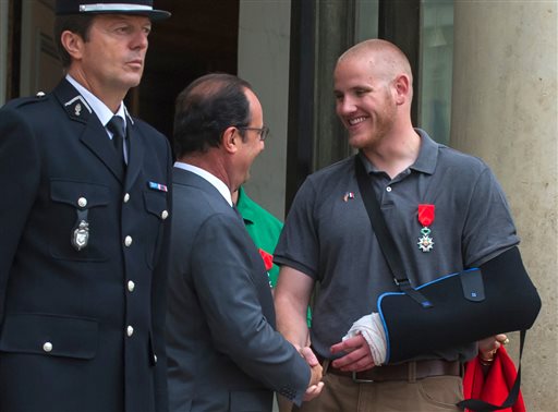 French President Francois Hollande shakes hands with U.S. Airman Spencer Stone outside the Elysee Palace in Paris after Hollande awarded Stone and two friends with the French Legion of Honor for subduing a gunman