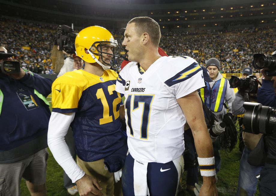 Packers quarterback Aaron Rodgers talks with his Chargers counterpart Philip Rivers after Green Bay’s win