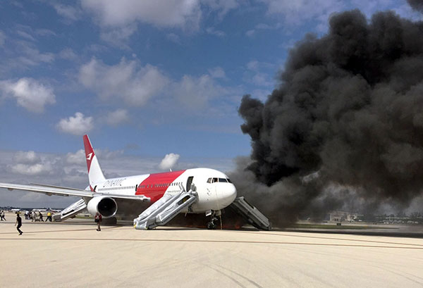 Passengers evacuate from a plane on fire at Fort Lauderdale airport Florida. — AFP