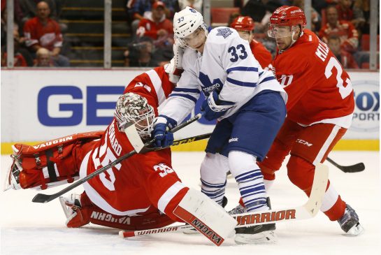 Mark Arcobello centre who scored one of two Toronto goals Friday collides with Detroit goalie Jimmy Howard