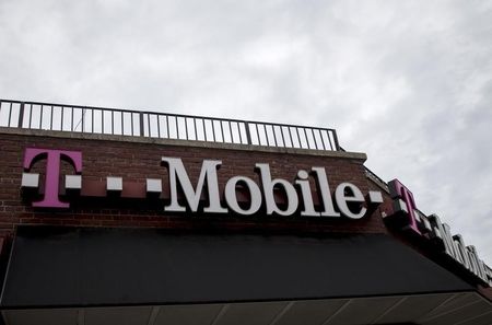 People pass by a T Mobile store in the Brooklyn borough of New York