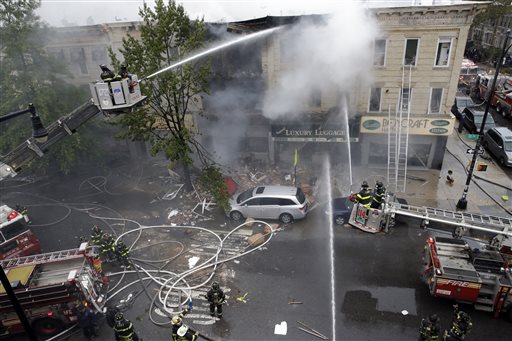 Firefighters work at the at the scene of an explosion at a three-story building in the Borough Park neighborhood in the Brooklyn borough of New York Saturday Oct. 3 2015. Firefighters in New York say one person is dead and three more have been injured