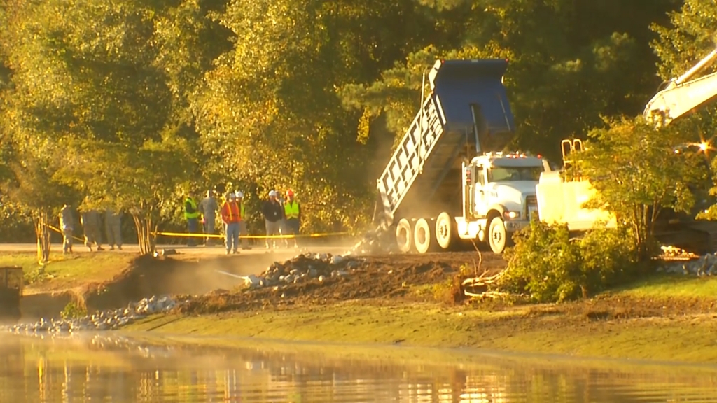 Crews work to stabilize dam after flooding