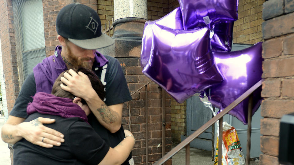 FAMILY GRIEVES Leona Phaneuf and Kris Posterro embrace at the small memorial they made