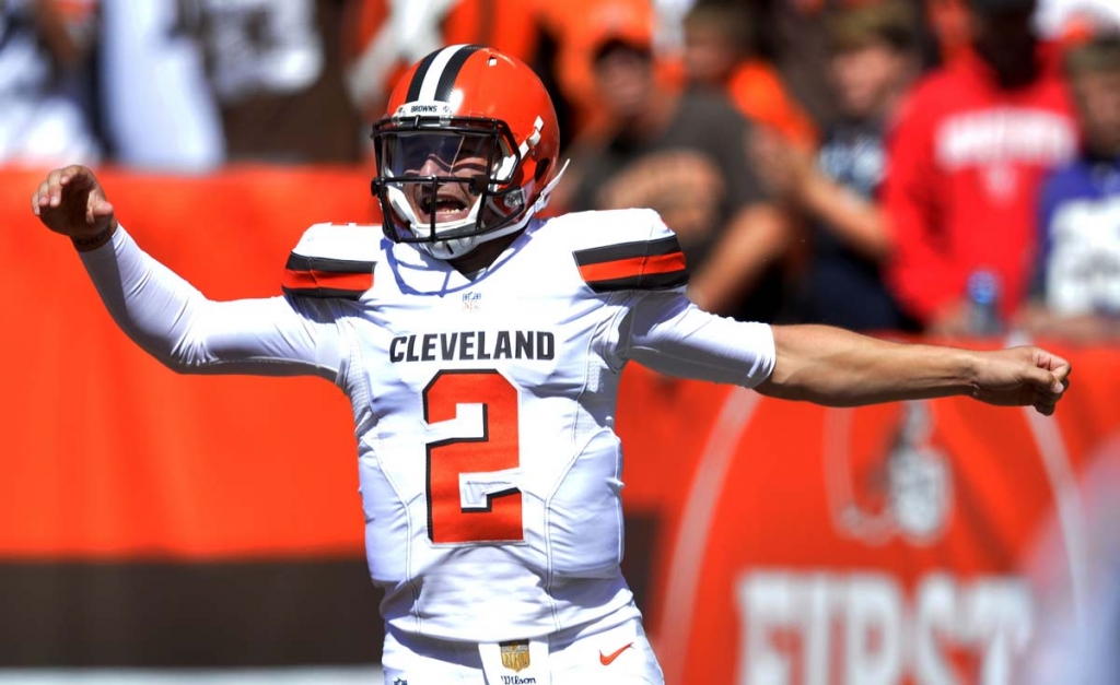 Cleveland Browns quarterback Johnny Manziel celebrates after a 60-yard touchdown pass to wide receiver Travis Benjamin in the first half of an NFL football game against the Tennessee Titans in Cleveland