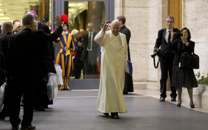 Pope Francis waves as he leaves at the end of the synod