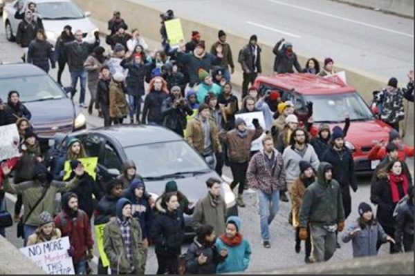 Protesters block cars on the freeway during a protest over the police shooting of Tamir Rice in Cleveland Nov. 25 2014