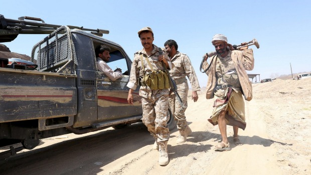 Soldiers loyal to Yemen's government walk at the frontline of fighting against Houthi militant on October 6