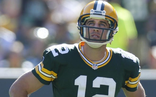 Aaron Rodgers watches the replay on the scoreboard of one of his two interceptions against the St. Louis Rams