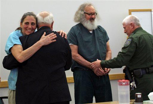 Evi Quaid left hugs attorney Peter Langrock and she and her husband actor Randy Quaid have their handcuffs removed in court Thursday Oct. 15 2015 in St. Albans Vt. A Vermont judge released the couple who says they'll now address 5-year-old crimin