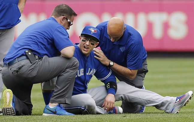 Toronto Blue Jays staff tend to Toronto Blue Jays shortstop Troy Tulowitzki center after he collided with Blue Jays center fielder Kevin Pillar fielding a fly ball during a baseball game at Yankee Stadium in New York Sept. 12 2015. Injured Blue Jays