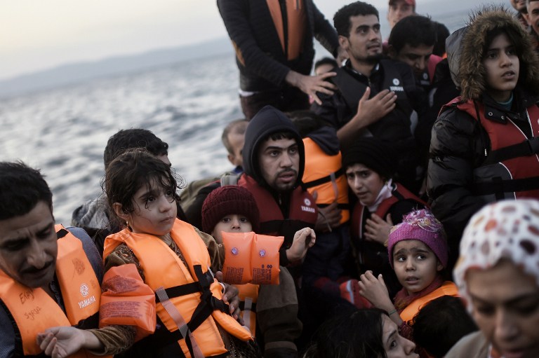 Refugees and migrants arrive at the Lesbos island after crossing the Aegean Sea from Turkey