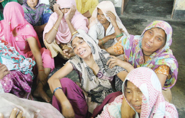 Relatives of victims of an arson assault on a family home mourn following the attack in Faridabad in this file