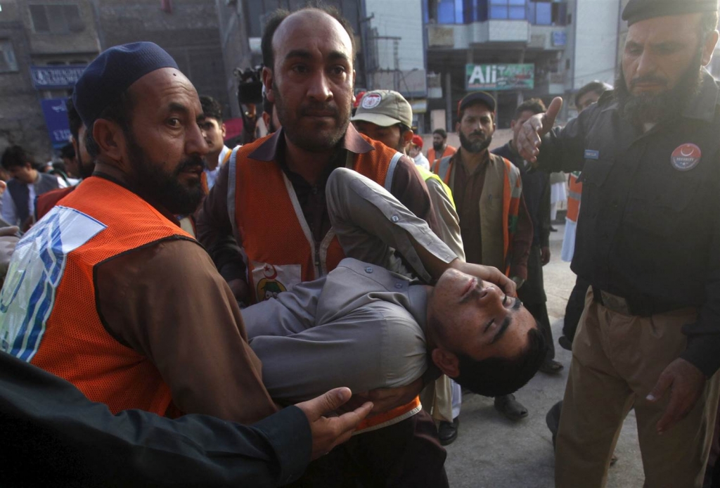 Image Rescue workers carry an injured man