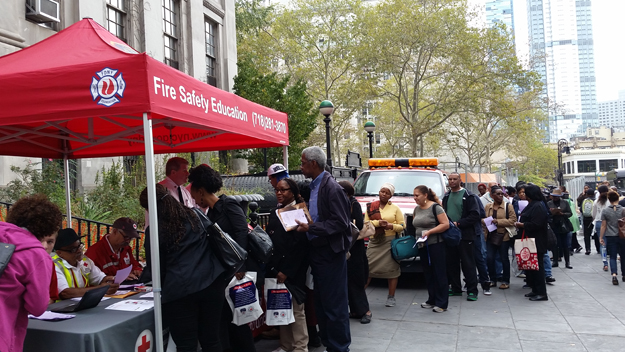 Residents pick up free smoke detectors at Brooklyn Borough Hall on Oct. 9 2015